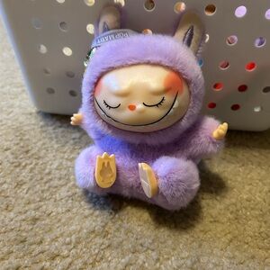 Purple labubu eyes closed yoga relaxation